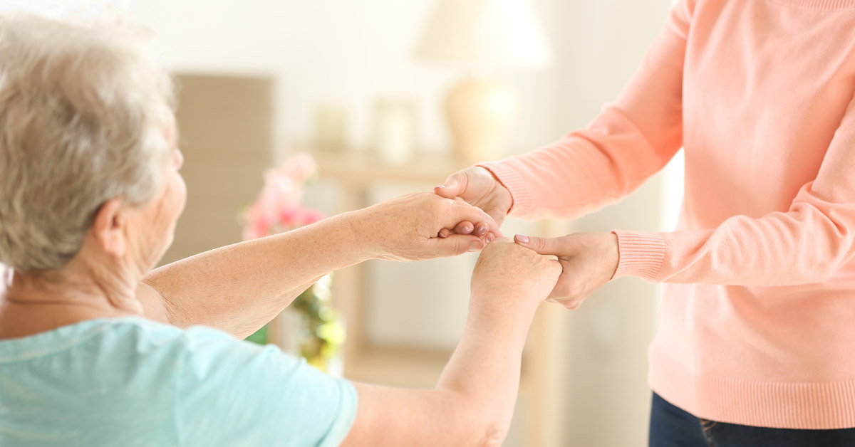 Understanding Domiciliary Care. Senior Lady Holding The Hands Of A Caretaker.