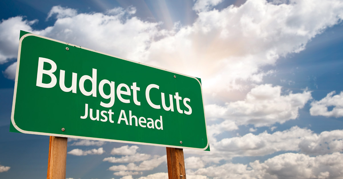 Roadside Sign Showing Budget Cuts Ahead